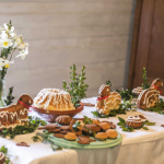 Babka wielkanocna, pierniczki i baranki wielkanocne, bukszpan i żonkile na świątecznym stole.